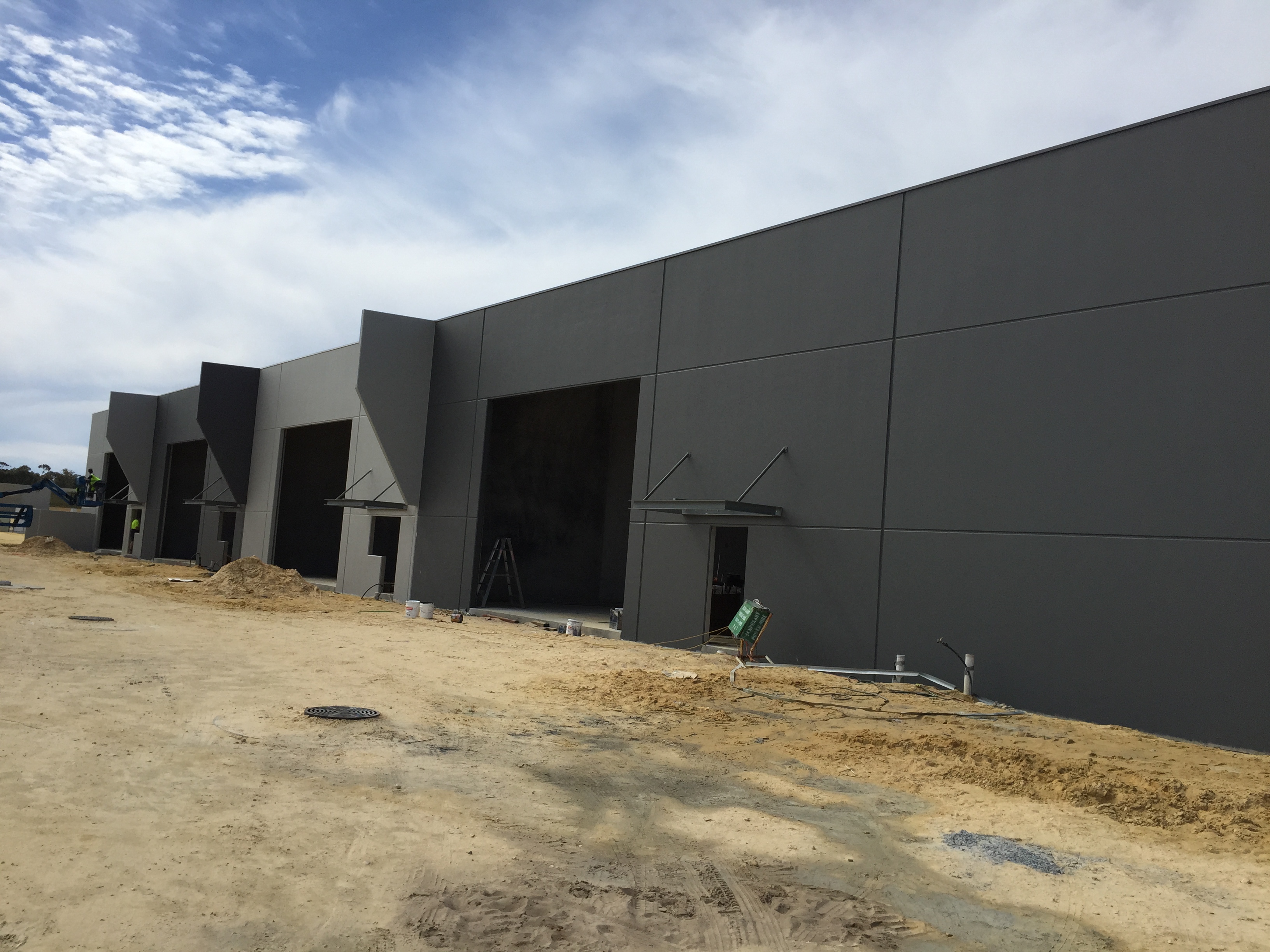 Exterior shot of large commercial building painted in dark grey
