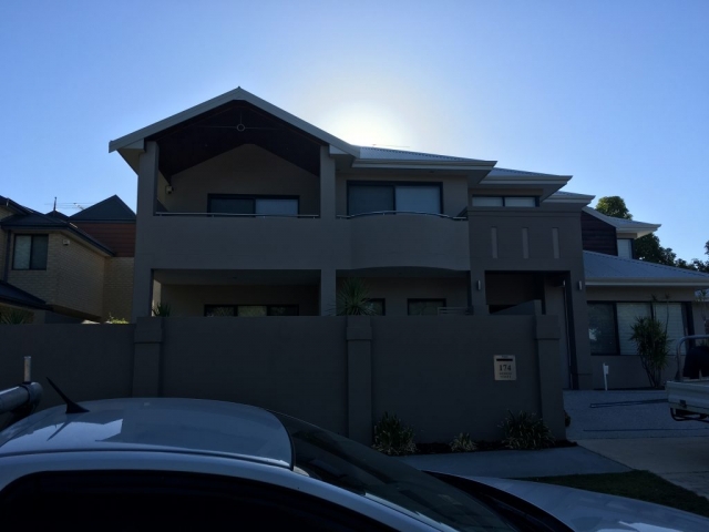 Large residential home painted dark grey