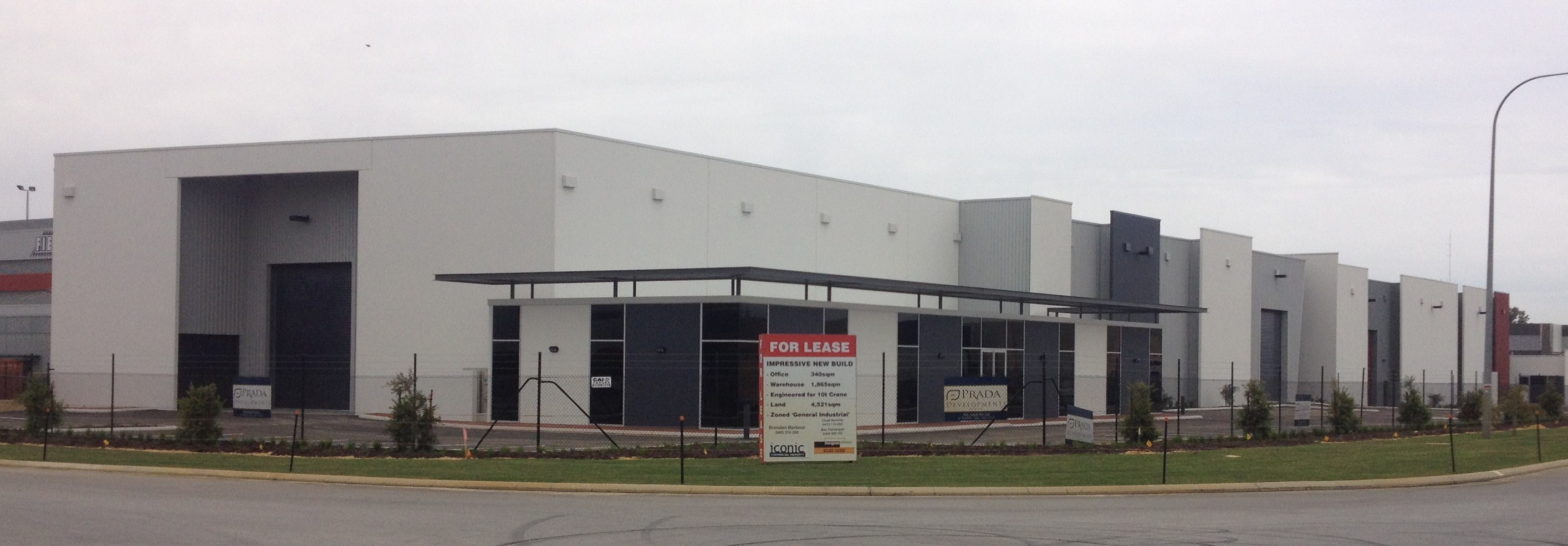 Exterior of commercial warehouse units, finished in tones of grey