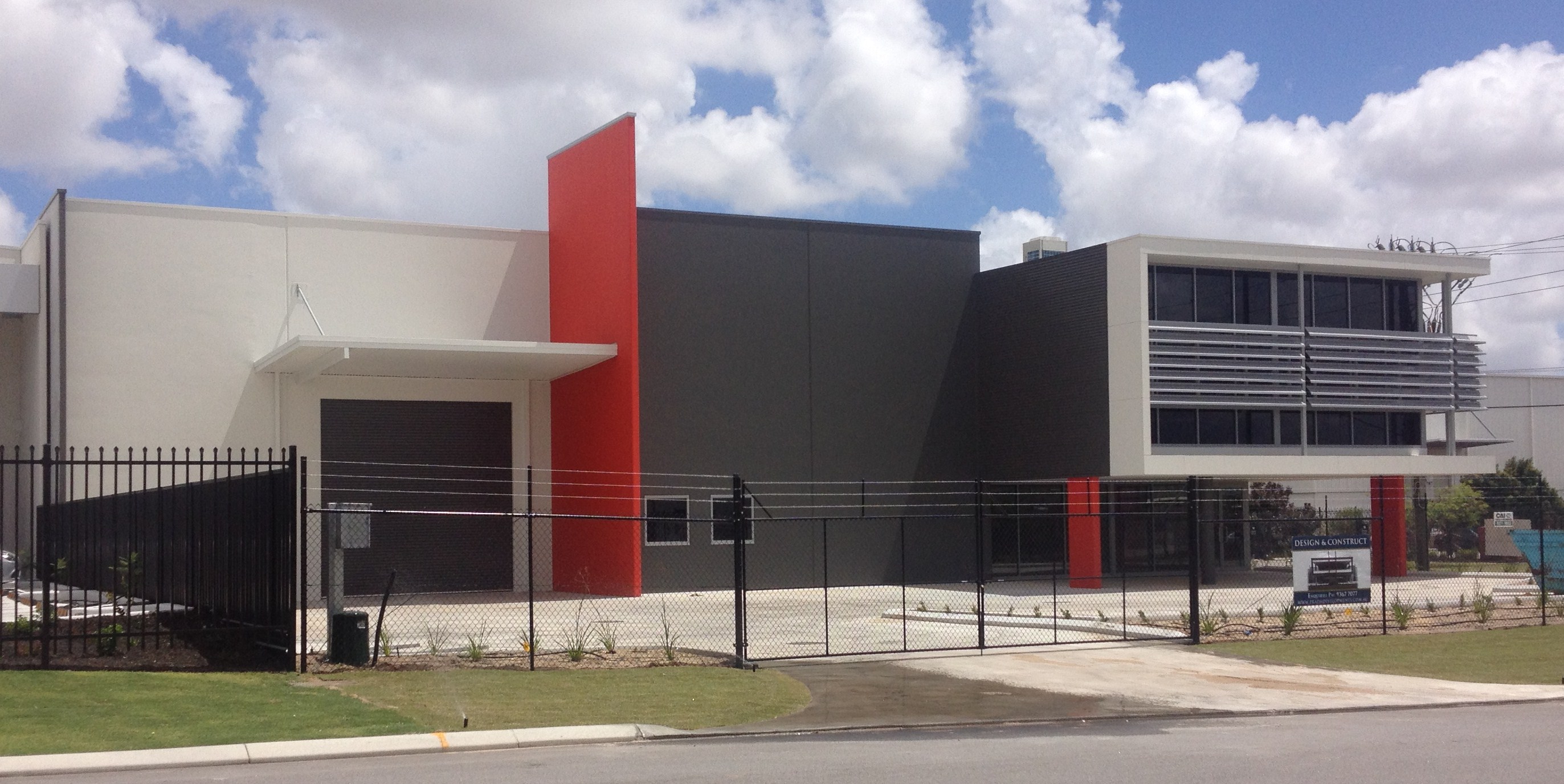 Red and grey painted commercial warehouse unit exterior