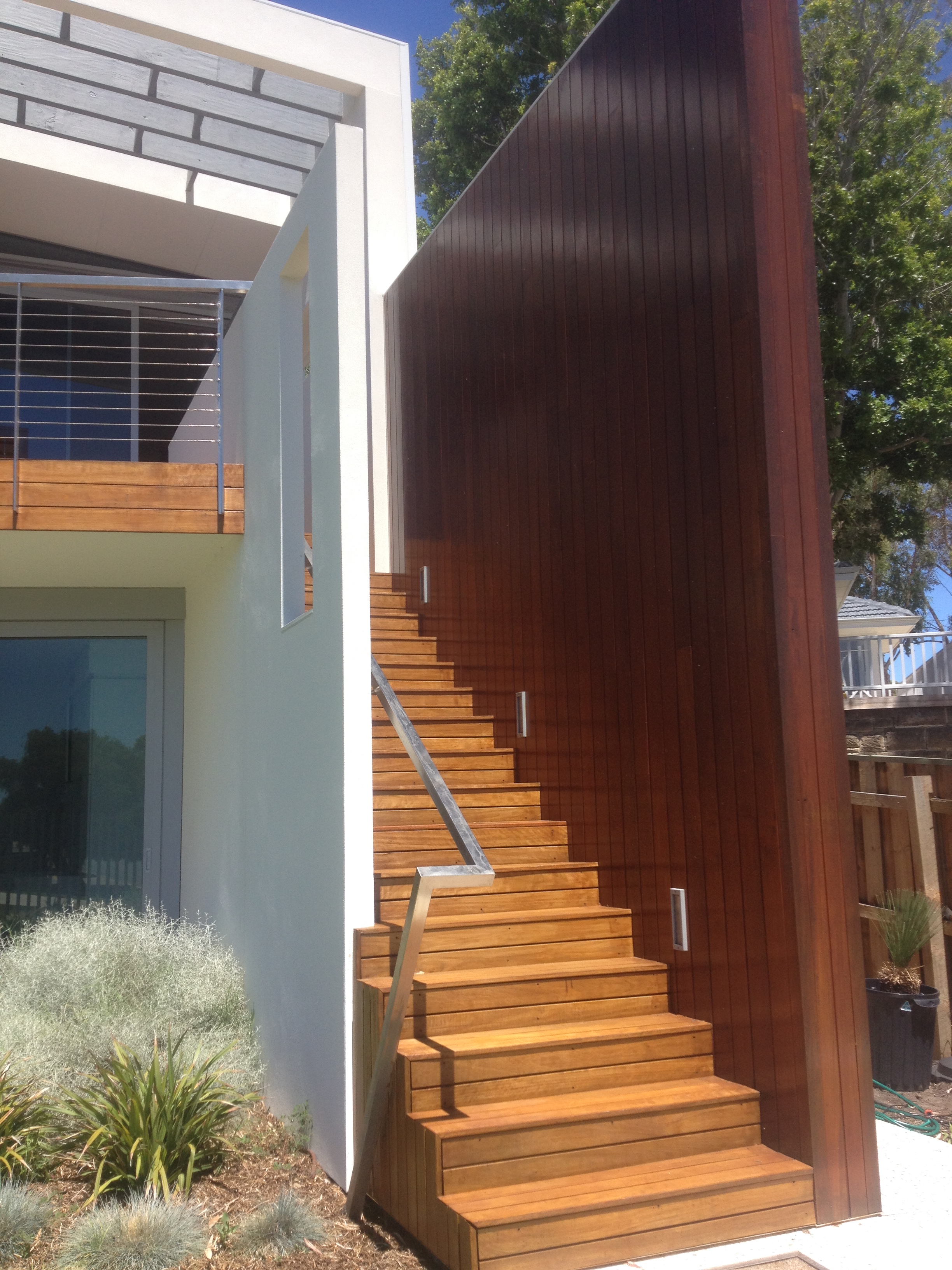 Shot of wooden exterior staircase painted in light and dark brown stain