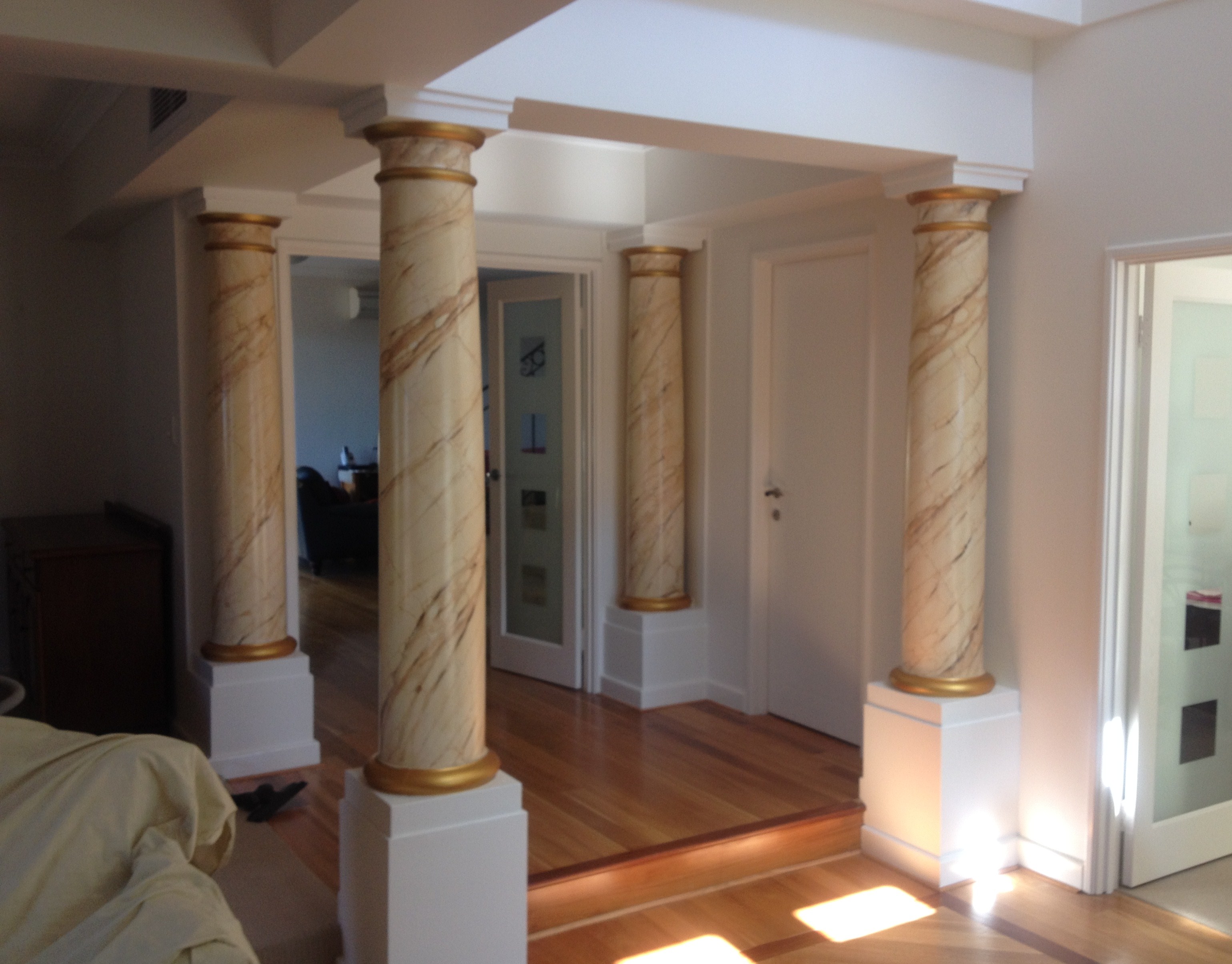 Interior shot of white painted walls and feature marble pillars