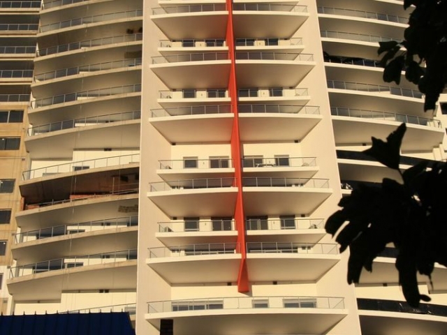 Large multilevel apartment complex painted in cream and orange