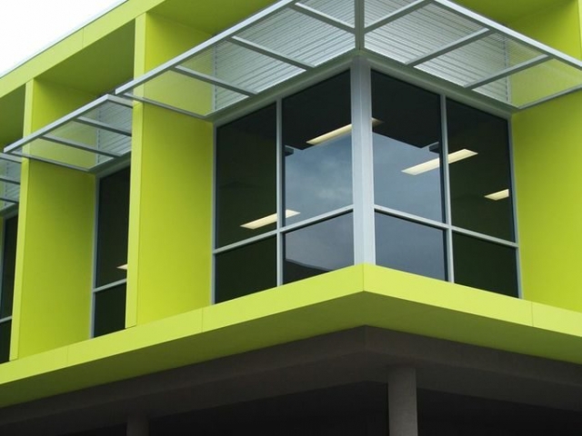 Exterior corner of commercial office block, finished in vibrant lime green